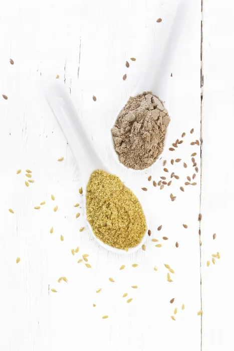 Framed Print : Flaxseed bran and flour in two spoons