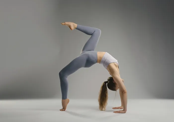 Framed Print : A flexible woman executes a backbend yoga pose