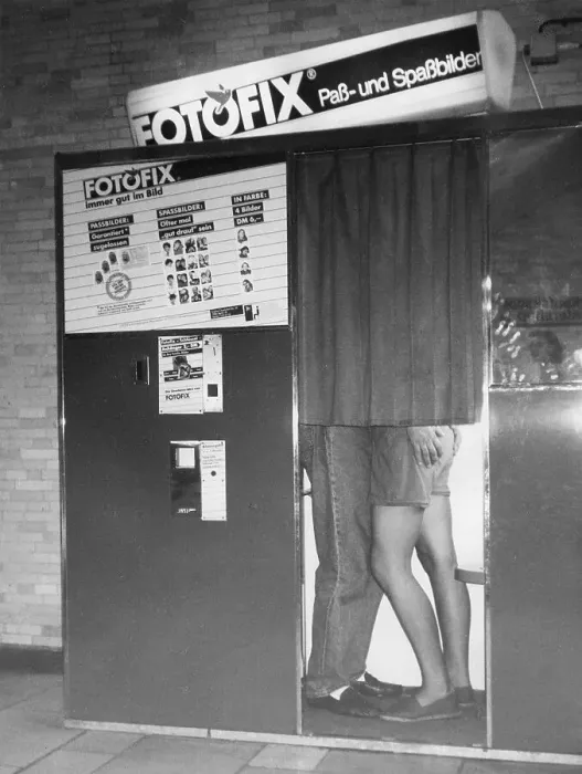 Framed Print : Flirting in a photo booth, ca. 1980s