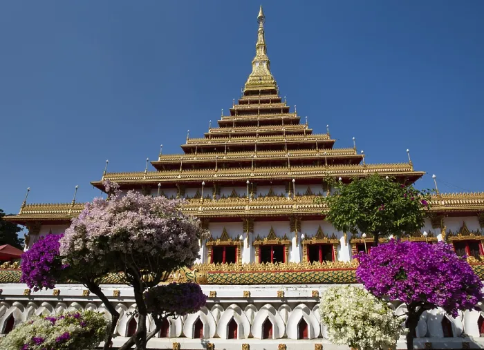 Framed Print : Flowering bushes in front of nine-story stupa Phra Mahathat Kaen Kakhon