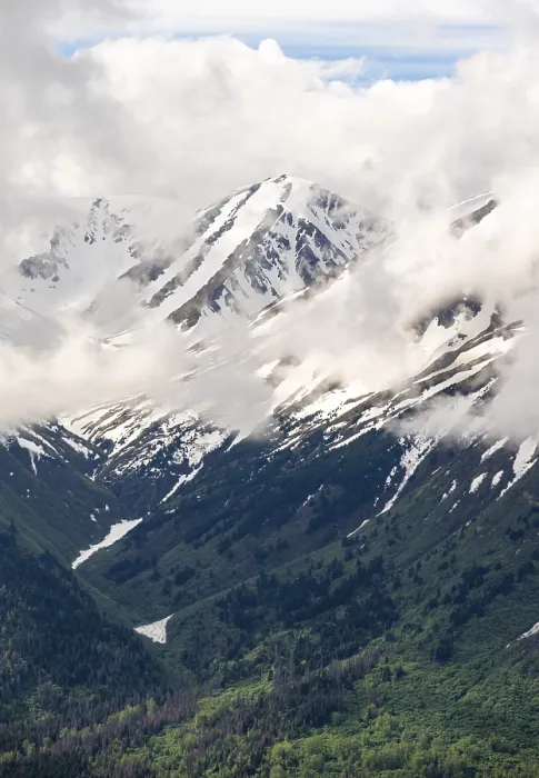 Framed Print : Fog sweeps around mountain peaks with remnants of snow