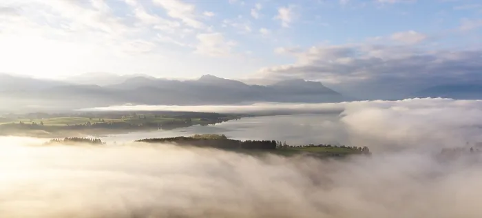 Framed Print : Foggy landscape with view of Lake Forggensee and mountain skyline in the background