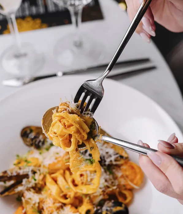 Framed Print : Food, Close-up of a person twirling fork with seafood pasta in a fine dining setting