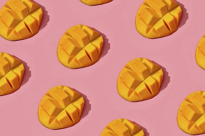 Framed Print : Food design. Top view of colorful fruit pattern of fresh juicy cutted into cubes mango on coral pink pastel background