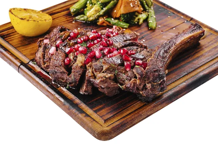 Framed Print : Food, Sliced grilled pork steak with pomegranate seeds and asparagus