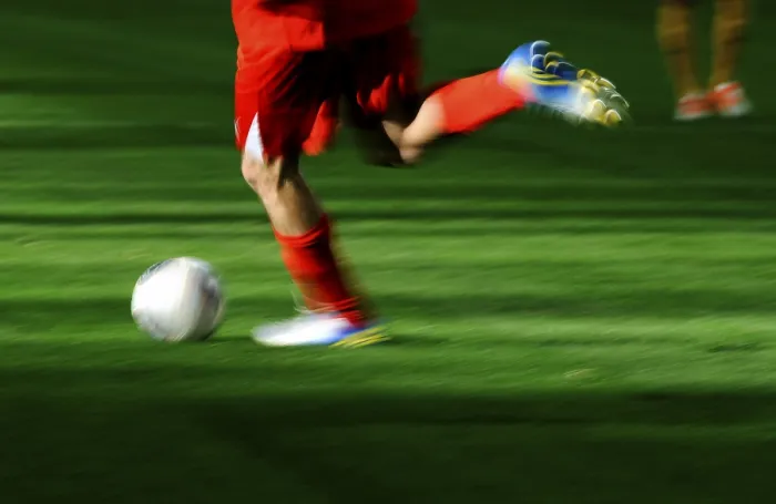 Framed Print : A football player's legs with a football Framed Print : A football player's legs with a football