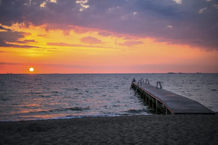Framed Print : Footbridge at sunrise over the sea