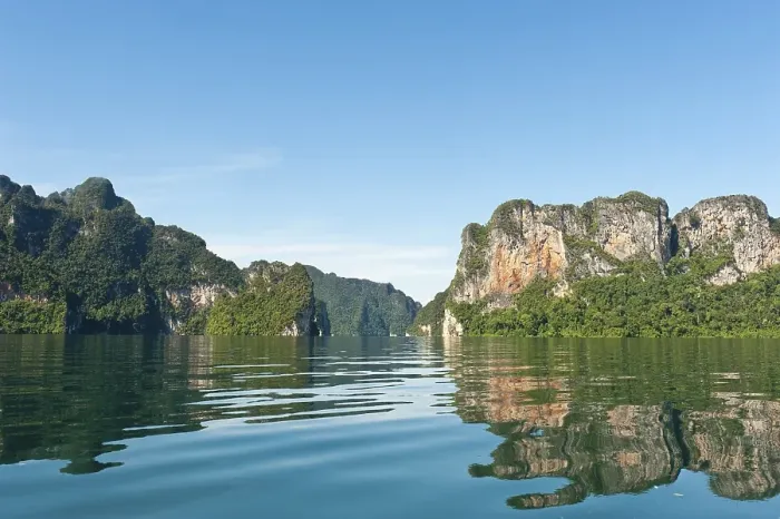 Framed Print : Forested karst limestone mountains reflected in the water