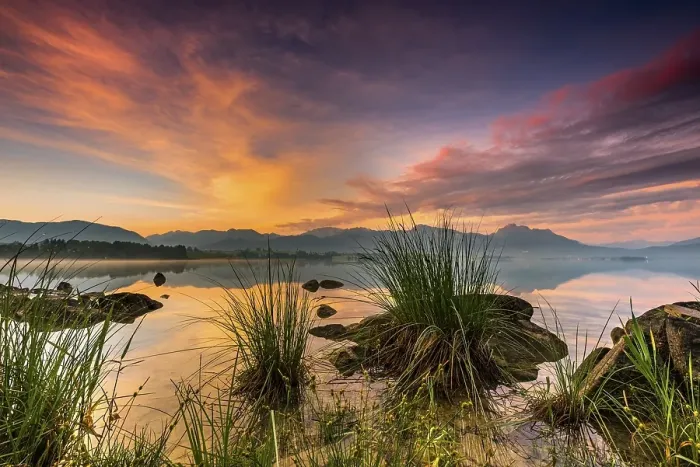 Framed Print : Forggensee with reflection of the cloudy sky and the Allgaeuer mountains in the background at sunrise Framed Print : Forggensee with reflection of the cloudy sky and the Allgaeuer mountains in the background at sunrise