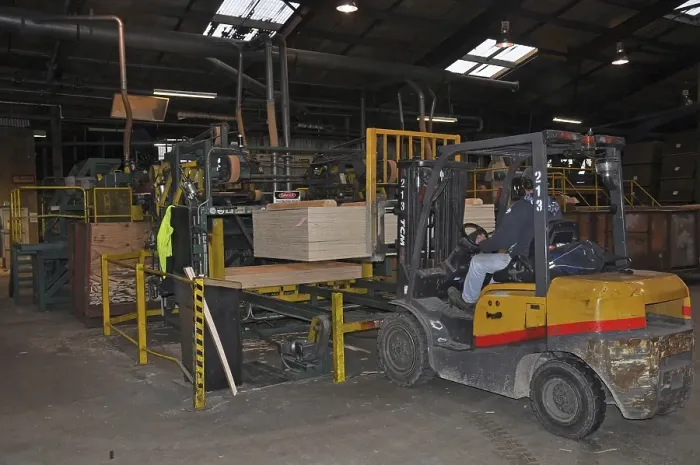Framed Print : Forklift carries a pallet of completed plywood at the factory Framed Print : Forklift carries a pallet of completed plywood at the factory