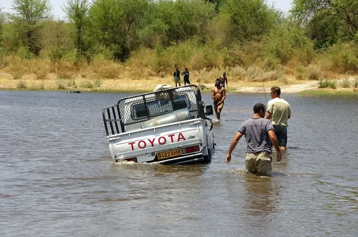 Framed Print : Four-wheel drive jeep booged down while crossing a river