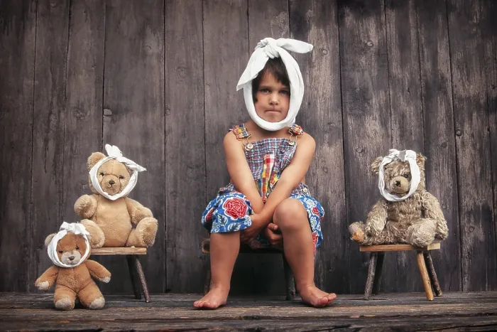 Framed Print : Four-year girl and teddy bears with toothache