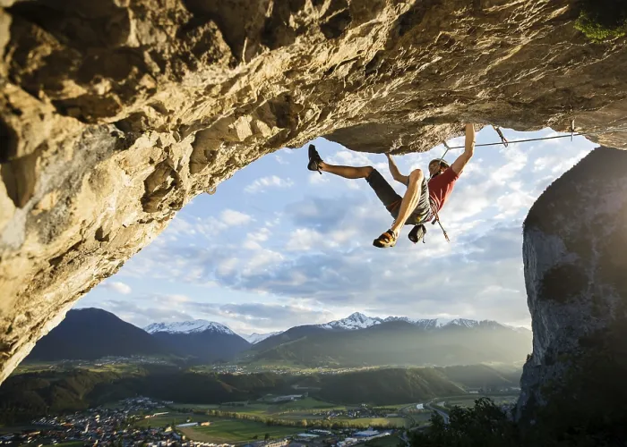 Framed Print : Freeclimber with helmet climbing on a rock face