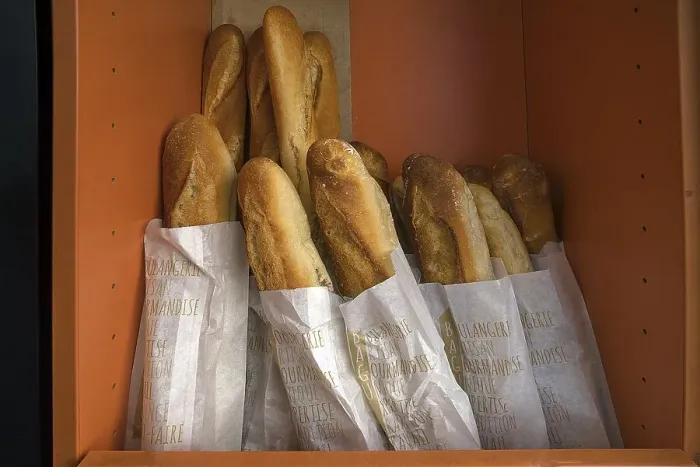Framed Print : Fresh baguettes in a bread box of a bakery