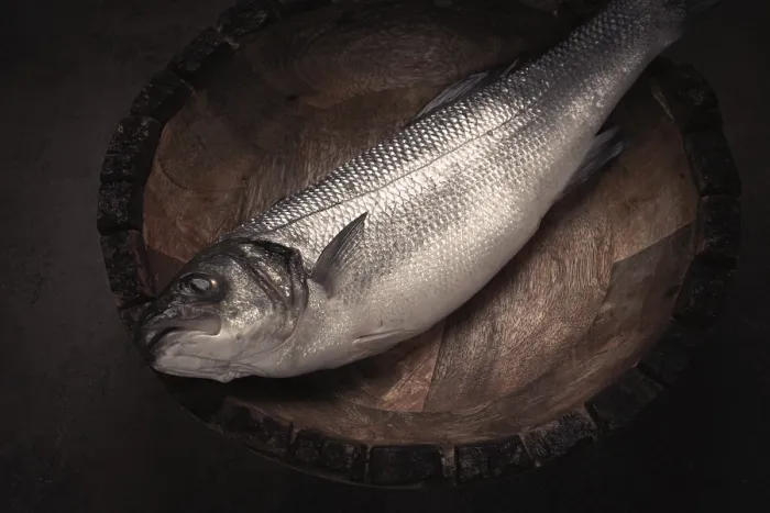 Framed Print : Fresh, raw sea bass fish, in a wooden plate Framed Print : Fresh, raw sea bass fish, in a wooden plate