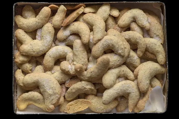 Framed Print : Freshly baked vanilla crescents in a tin