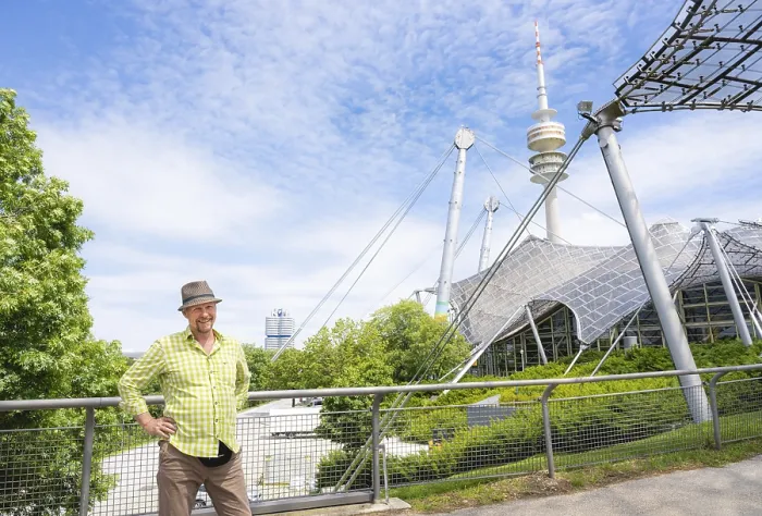 Framed Print : Friendly smiling man at the Olympic tower with Olympic tent roof
