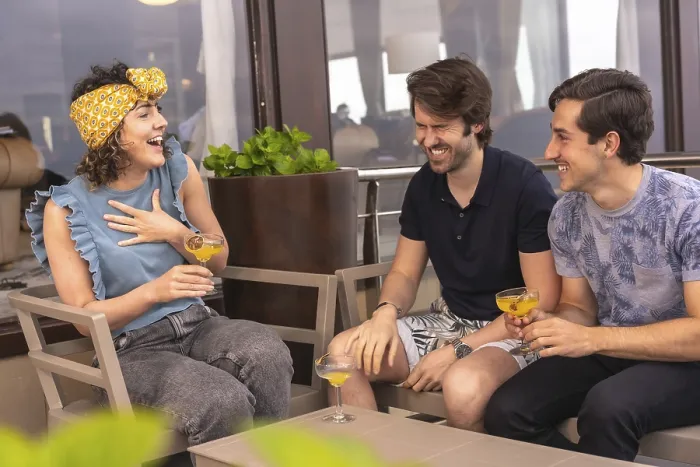 Framed Print : Friends having fun and laughing drinking cocktails in a terrace