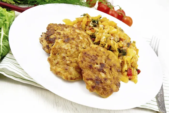 Framed Print : Fritters of minced meat with stewed cabbage in a plate
