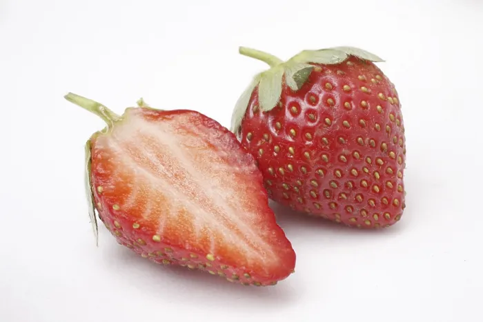 Framed Print : Fruit, Strawberry Fragaria Ananassa one full and half on white background