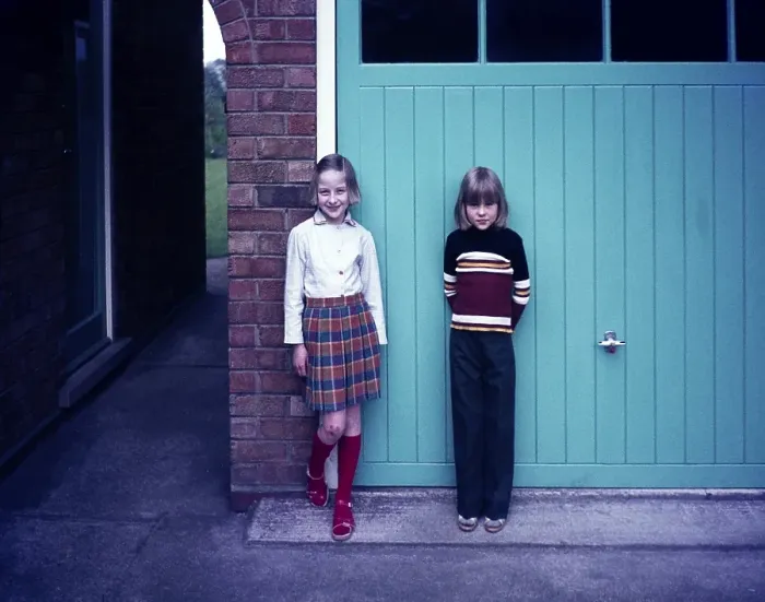 Framed Print : Full-length portrait of two young girls standing in front of the garage of a house, 1960s or 1970s Framed Print : Full-length portrait of two young girls standing in front of the garage of a house, 1960s or 1970s