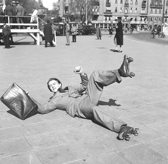 Framed Print : Fun in the 1940s. A young man on rollerskates has lost his balance and lies on the ground