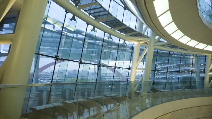 Framed Print : Futuristic atrium environment, glass wall and metallic construction inside big public hall with sitting man