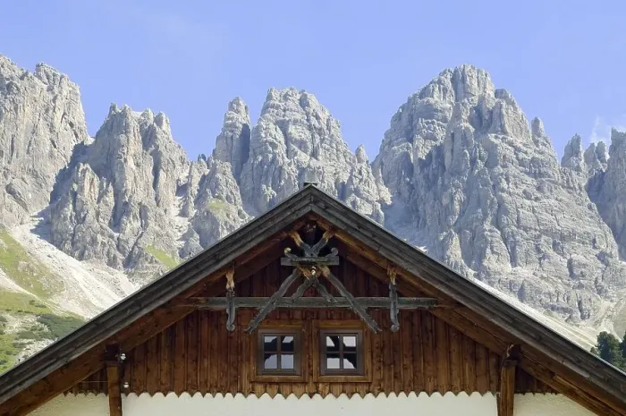 Framed Print : Gable of an alpine building, Kalkkoegel mountain chain at back