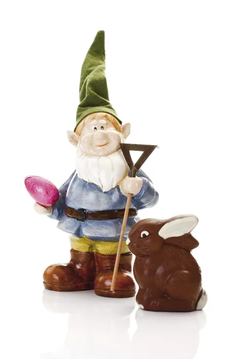 Framed Print : Garden gnome with a rake and an easter egg standing in front of a chocolate easter bunny Framed Print : Garden gnome with a rake and an easter egg standing in front of a chocolate easter bunny