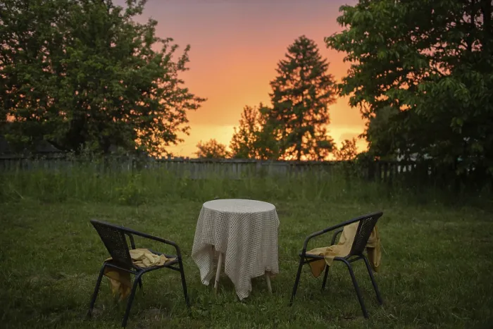 Framed Print : Garden scene with two chairs and a table under a sunset sky Framed Print : Garden scene with two chairs and a table under a sunset sky