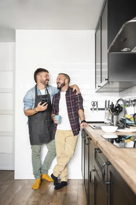 Framed Print : A gay couple standing close in a modern kitchen Framed Print : A gay couple standing close in a modern kitchen