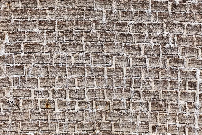 Framed Print : General view of a textured brick wall in earthy tones with an antique look