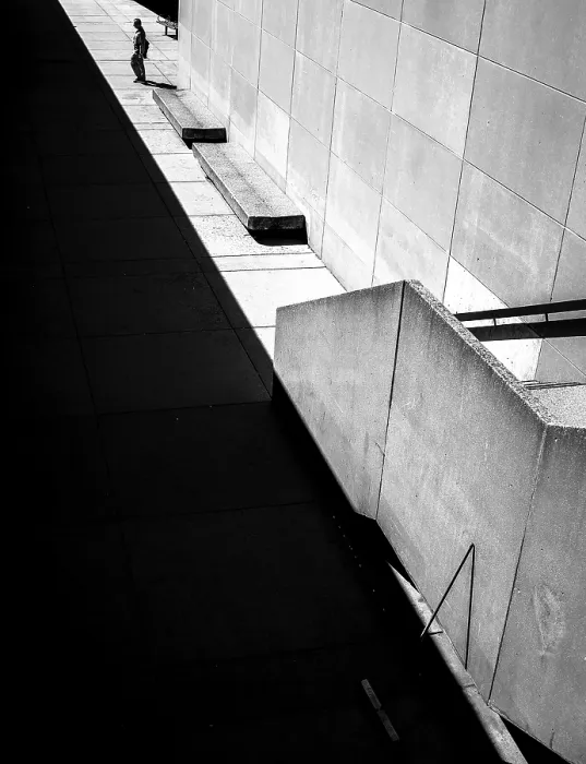 Framed Print : Geometric black and white scene with sharp shadows and a solitary person against a wall in Toronto
