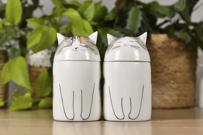 Framed Print : Germany, October 2023: Two custom made cat pet urns on table