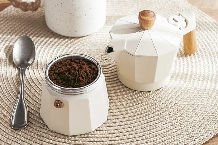 Framed Print : Geyser coffee maker with ground coffee and a spoon on the background of a woven rug Framed Print : Geyser coffee maker with ground coffee and a spoon on the background of a woven rug
