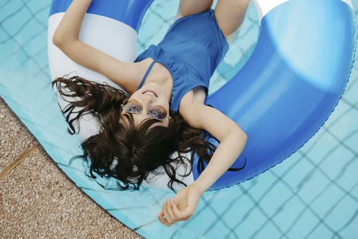 Framed Print : Girl, 10, swims in a swimming tyre in the pool