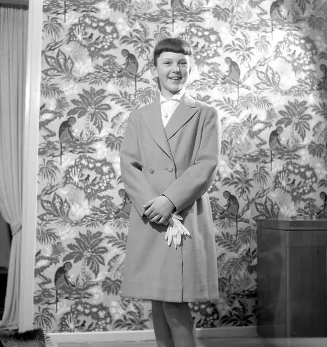 Framed Print : Girl in the 1950s. A teenage girl dressed in a coat of the typical look of the decade