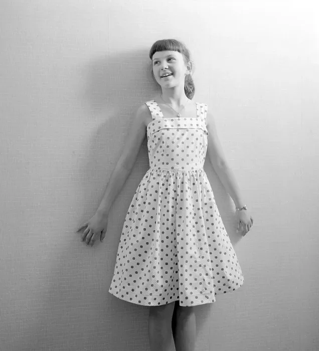 Framed Print : Girl in the 1950s. A teenage girl dressed in a patterned dress