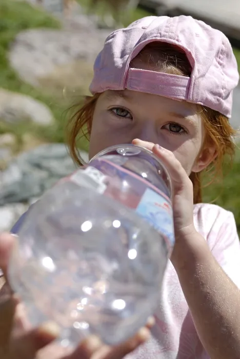 Framed Print : Girl drinking thurstily from a big water bottle