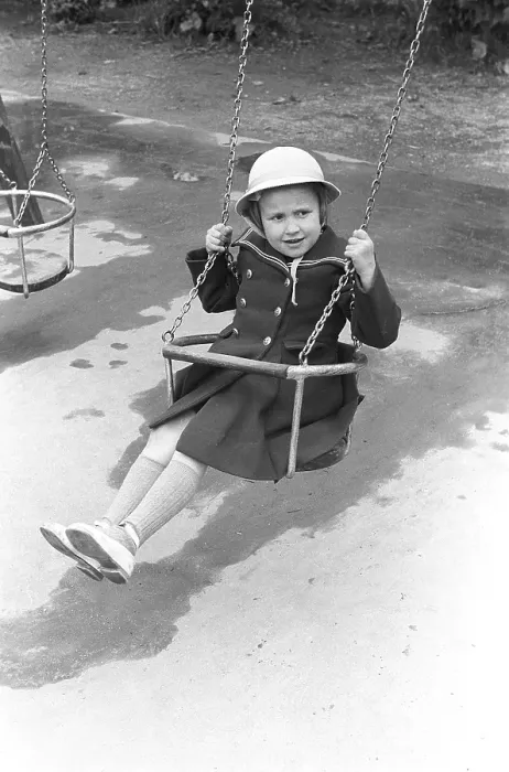 Framed Print : A girl in a playground in 1953. A girl dressed in fancy clothes and a hat is sitting in a swing in a playground. Kristoffersson ref 1-11 Framed Print : A girl in a playground in 1953. A girl dressed in fancy clothes and a hat is sitting in a swing in a playground. Kristoffersson ref 1-11