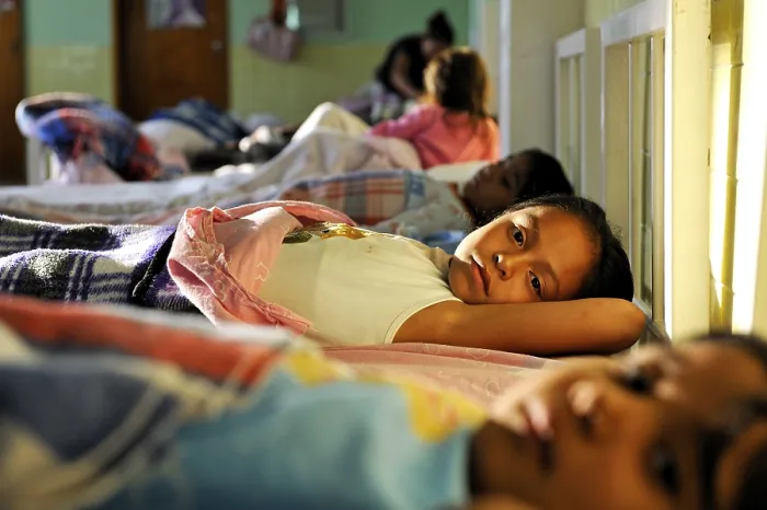 Framed Print : Girls going to sleep in the dormitory of an orphanage