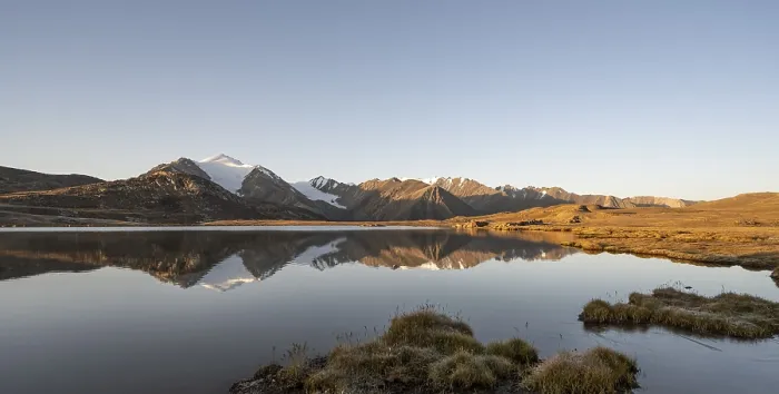 Framed Print : Glaciated mountain peaks reflected in a mountain lake at sunset Framed Print : Glaciated mountain peaks reflected in a mountain lake at sunset