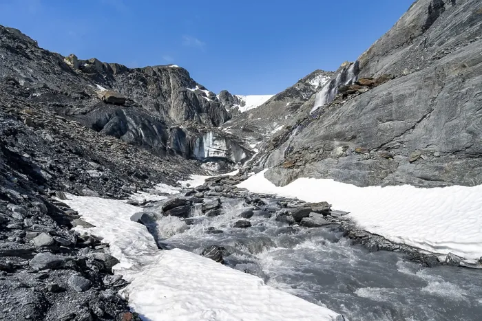 Framed Print : Glacier ice and glacier stream with waterfall