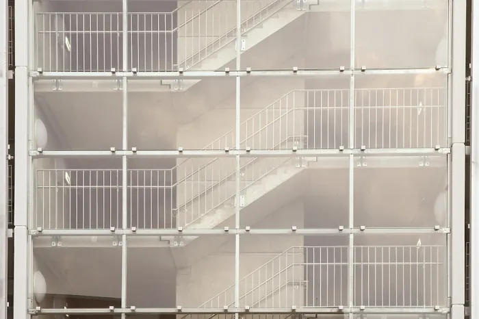 Framed Print : Glass facade of a modern building revealing staircases with metal railings