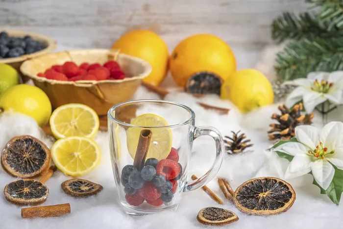 Framed Print : Glass with fresh berries, oranges and lemons in the background Framed Print : Glass with fresh berries, oranges and lemons in the background