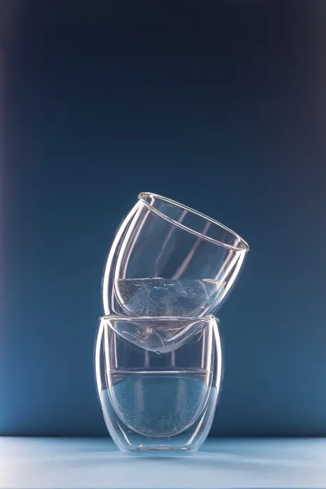 Framed Print : Two glasses with water on a blue background with copy space
