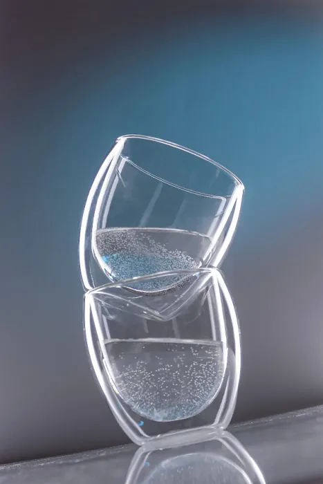 Framed Print : Two glasses with water on a slanted blue background Framed Print : Two glasses with water on a slanted blue background