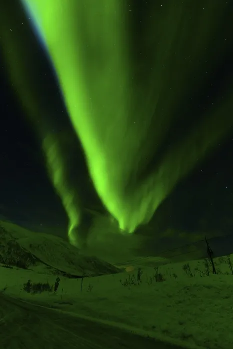 Framed Print : Glowing green aurora borealis fills the sky over a snowy landscape under a starry backdrop