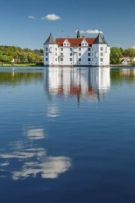 Framed Print : Glucksburg moated castle under a blue sky with white clouds Framed Print : Glucksburg moated castle under a blue sky with white clouds