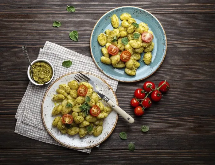 Framed Print : Gnocchi in plates with green pesto sauce